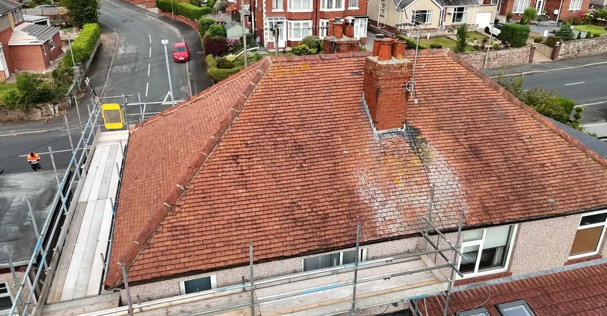 Red tiled roof and chimney seen from scaffolding during a job by All Fix Roofing